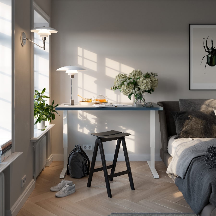 a room with a bed and a table and a chair